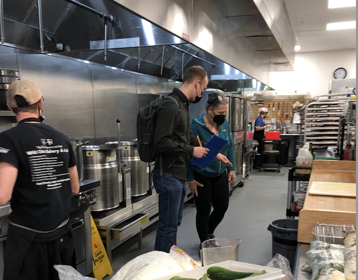 Two people talking in an industrial kitchen